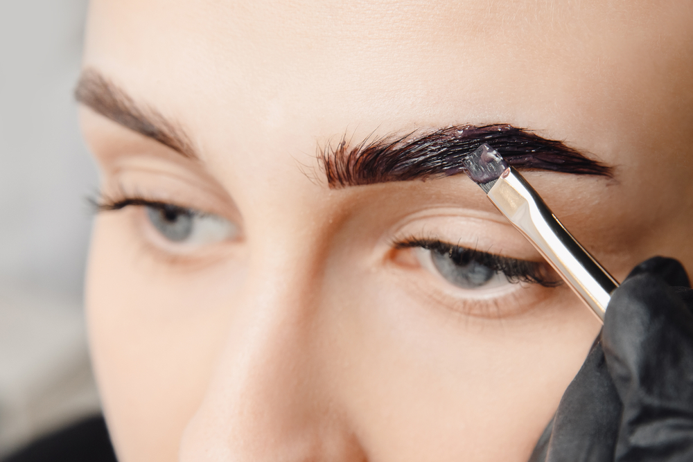 Woman getting a brow tint procedure